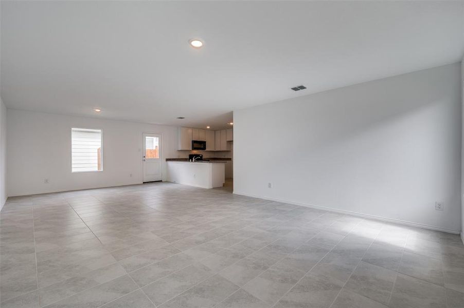 Unfurnished living room with light tile floors Unfurnished living room with light tile floors