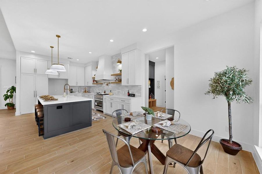 Dining area featuring wood finish floors and recessed lighting