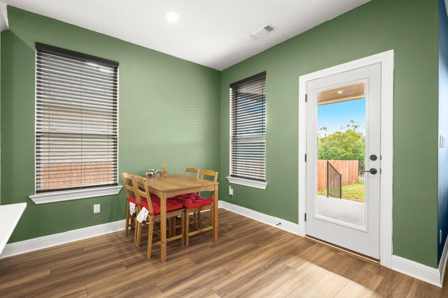 Dining space with wood finished floors and recessed lighting Dining space with wood finished floors and recessed lighting