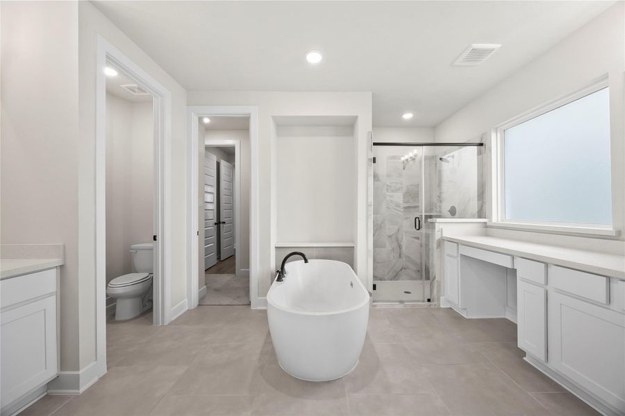 The primary bathroom features a modern design with a freestanding tub, a spacious glass-enclosed shower, and ample natural light. It includes dual vanities and a separate toilet area, offering both functionality and elegance. The primary bathroom features a modern design with a freestanding tub, a spacious glass-enclosed shower, and ample natural light. It includes dual vanities and a separate toilet area, offering both functionality and elegance.