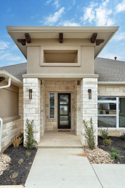 Front exterior of a new home in Santa Rita Ranch, Liberty Hill, TX, highlighting curb appeal (Image 18).