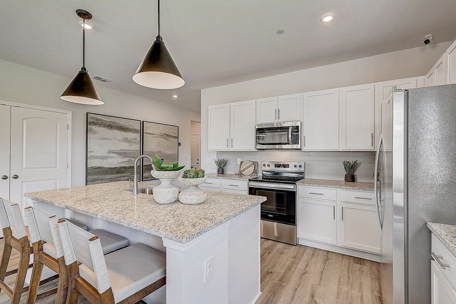 A kitchen with white cabinets.