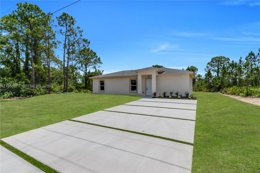 Front exterior of a new home in , Lehigh Acres, FL, highlighting curb appeal (Image 1). Front exterior of a new home in , Lehigh Acres, FL, highlighting curb appeal (Image 1).