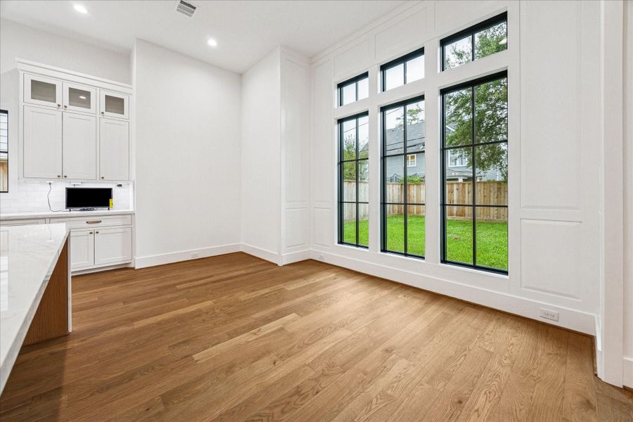 Expansive windows along the breakfast area flood the kitchen with natural light and open clear views to the backyard. Expansive windows along the breakfast area flood the kitchen with natural light and open clear views to the backyard.