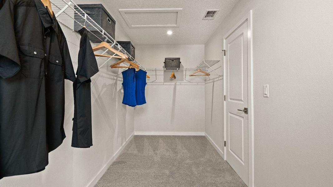 Primary Suite Walk-in Closet in the Model Highbourne by DRB Homes in Hamilton Bluff located in Haines City, FL. Primary Suite Walk-in Closet in the Model Highbourne by DRB Homes in Hamilton Bluff located in Haines City, FL.