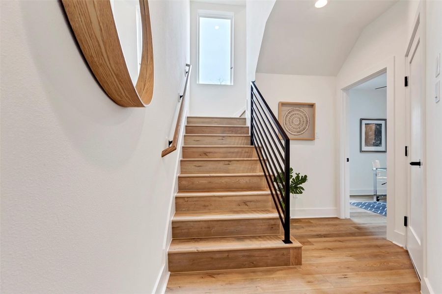Welcoming main entrance with a spacious foyer, featuring a staircase that leads to the second floor. To the right, a cozy bedroom awaits. Welcoming main entrance with a spacious foyer, featuring a staircase that leads to the second floor. To the right, a cozy bedroom awaits.