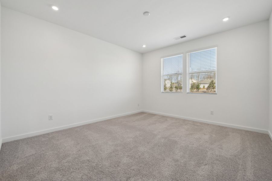 A room with a carpet and windows. A room with a carpet and windows.