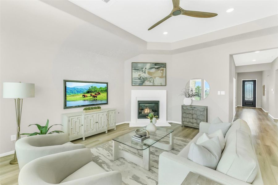 Light-filled living area emphasizing the "no carpet" luxury vinyl flooring and high-volume ceilings.
