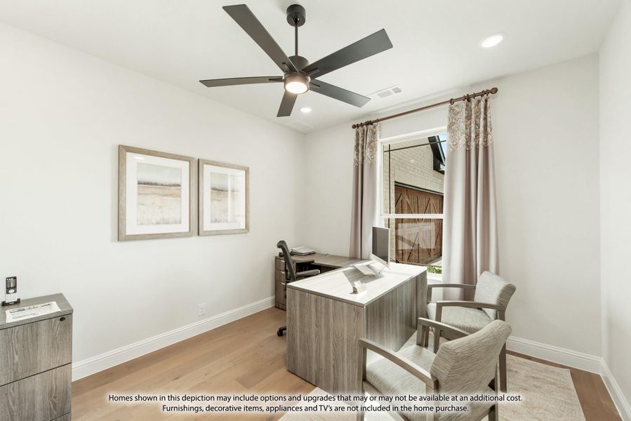 Home office with wood desk, ceiling fan, hardwood floors, and window with curtains Home office with wood desk, ceiling fan, hardwood floors, and window with curtains
