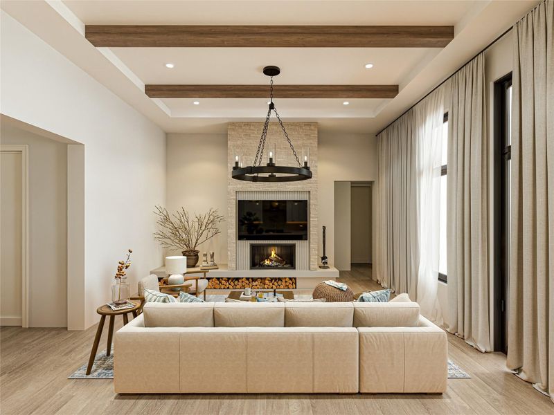 Exposed ceiling beams and a stone fireplace anchor this warm living space with wood flooring.