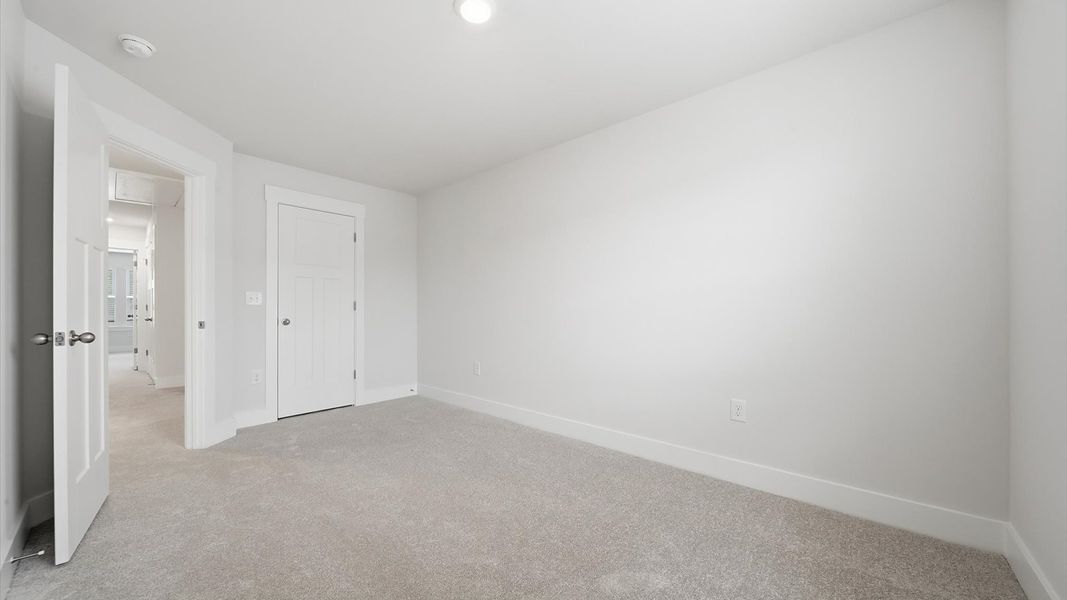 Vibrant and inviting secondary bedroom featuring a walk-in closet and refined finishes located at Saluda Crossing Vibrant and inviting secondary bedroom featuring a walk-in closet and refined finishes located at Saluda Crossing
