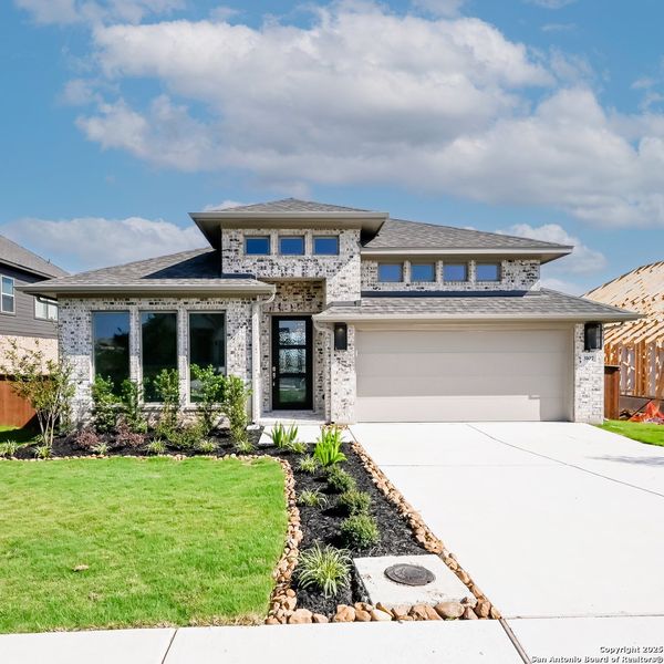 Front exterior of a new home in Homestead 65', Schertz, TX, highlighting curb appeal (Image 26). Front exterior of a new home in Homestead 65', Schertz, TX, highlighting curb appeal (Image 26).