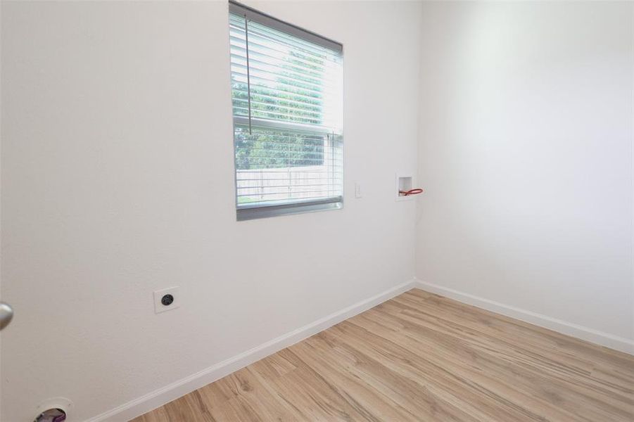 laundry room w light wood-style floors