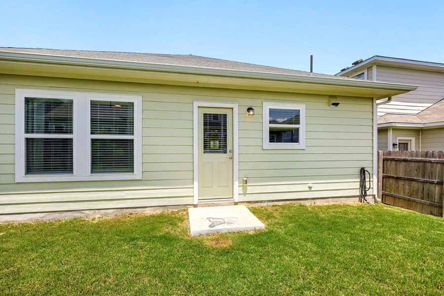 A well-maintained side yard features a fenced perimeter and accessible outdoor entry. A well-maintained side yard features a fenced perimeter and accessible outdoor entry.