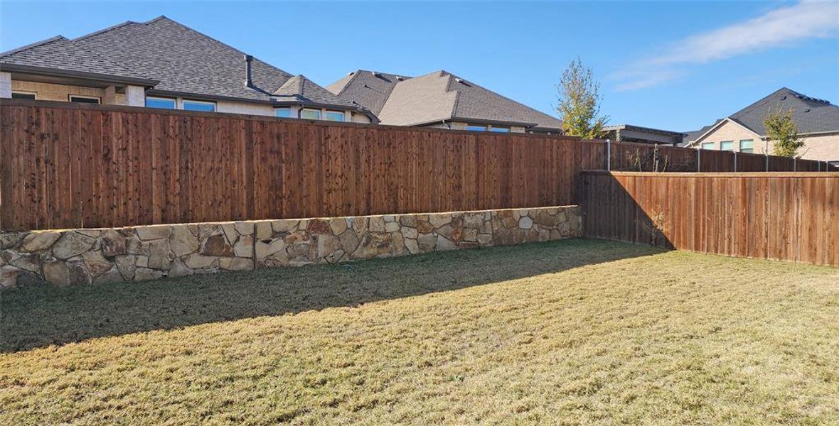 View of fenced backyard