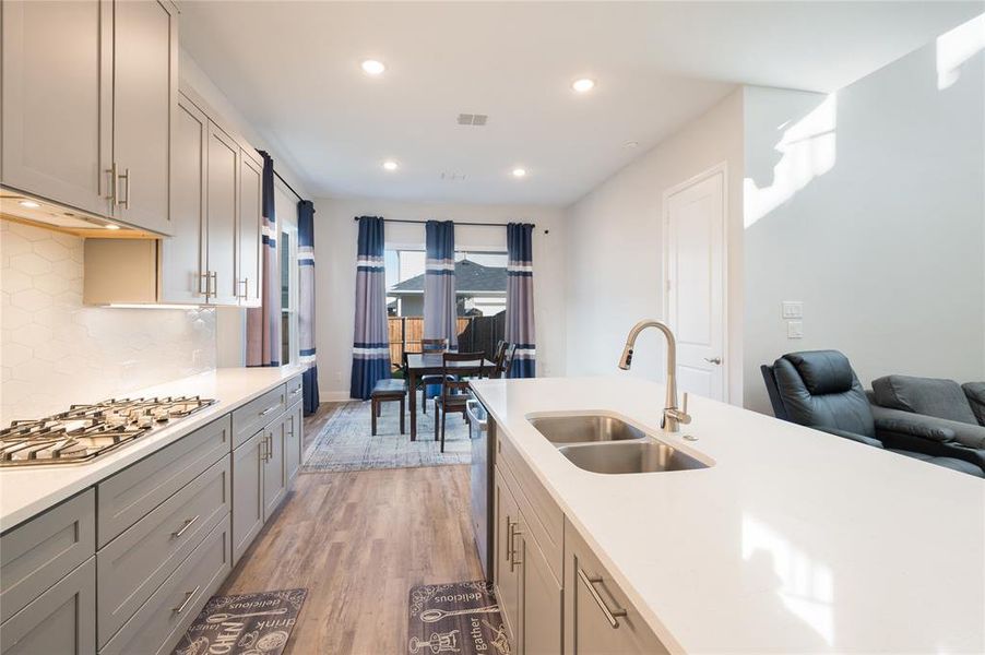 Gas stovetop, large double sink and lots of counter space.