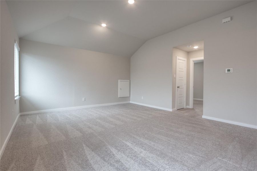 To the right of the game room is one of the secondary bedrooms. To the right of the game room is one of the secondary bedrooms.