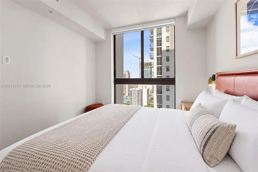 Floor-to-ceiling windows with dark framing and recessed ceiling lighting