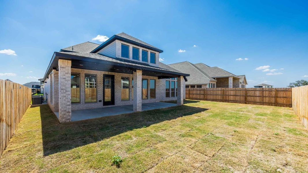 Back of house featuring a patio, a fenced backyard, a shingled roof, and brick siding Back of house featuring a patio, a fenced backyard, a shingled roof, and brick siding