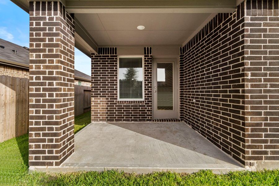 Exterior details and patio area of a home in Harrington Trails at The Canopies, Splendora (Image 3).