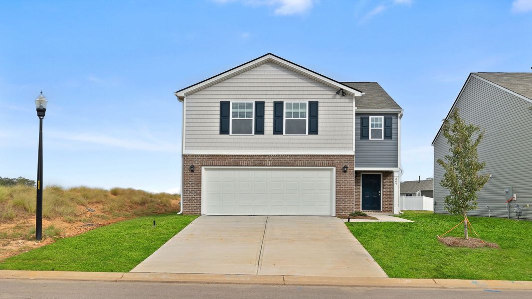 Front exterior of a new home in Durbin Meadows, Fountain Inn, SC, highlighting curb appeal (Image 1). Front exterior of a new home in Durbin Meadows, Fountain Inn, SC, highlighting curb appeal (Image 1).