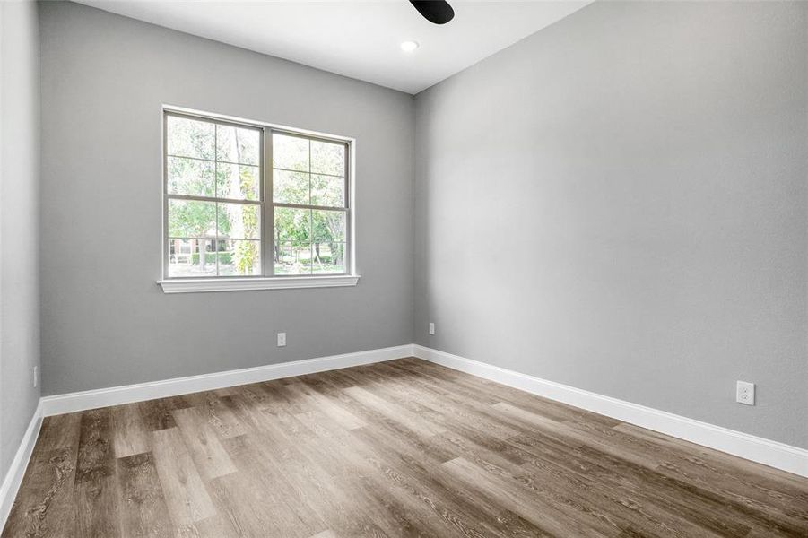 Empty room with wood finished floors and baseboards Empty room with wood finished floors and baseboards