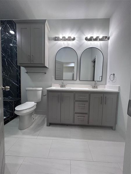 Full bathroom featuring double vanity and a shower Full bathroom featuring double vanity and a shower