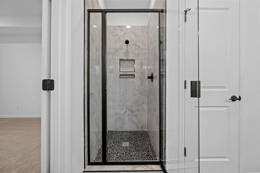 Bathroom featuring a shower with door