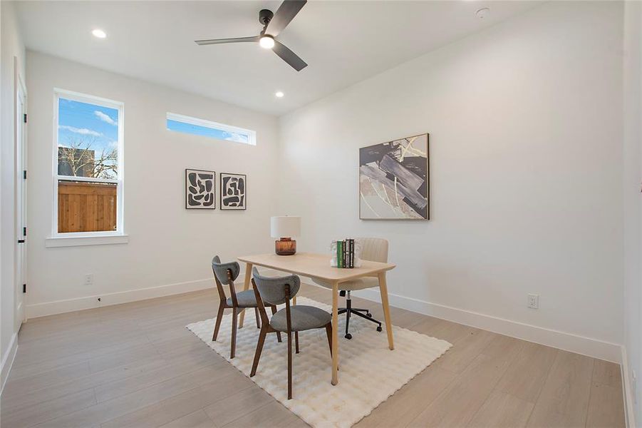 Office space featuring ceiling fan and light hardwood / wood-style flooring