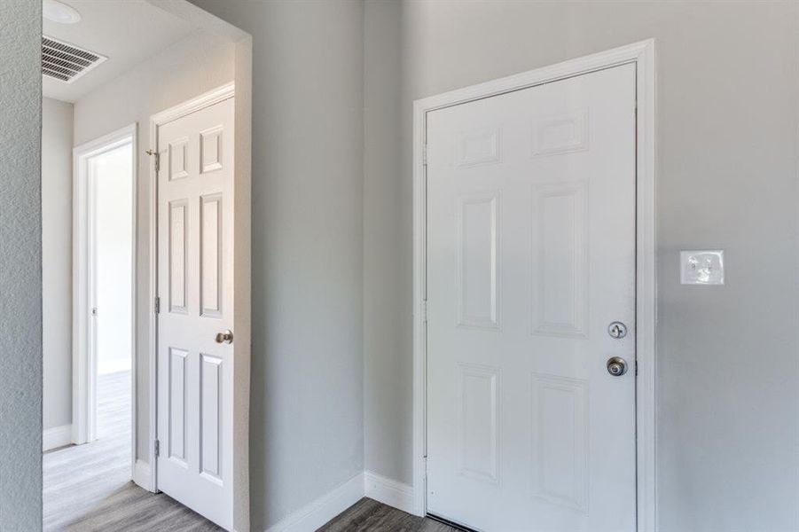Entryway featuring baseboards and wood finished floors