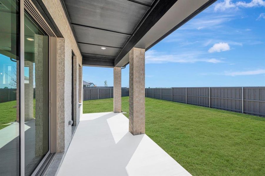 Fenced backyard with a patio