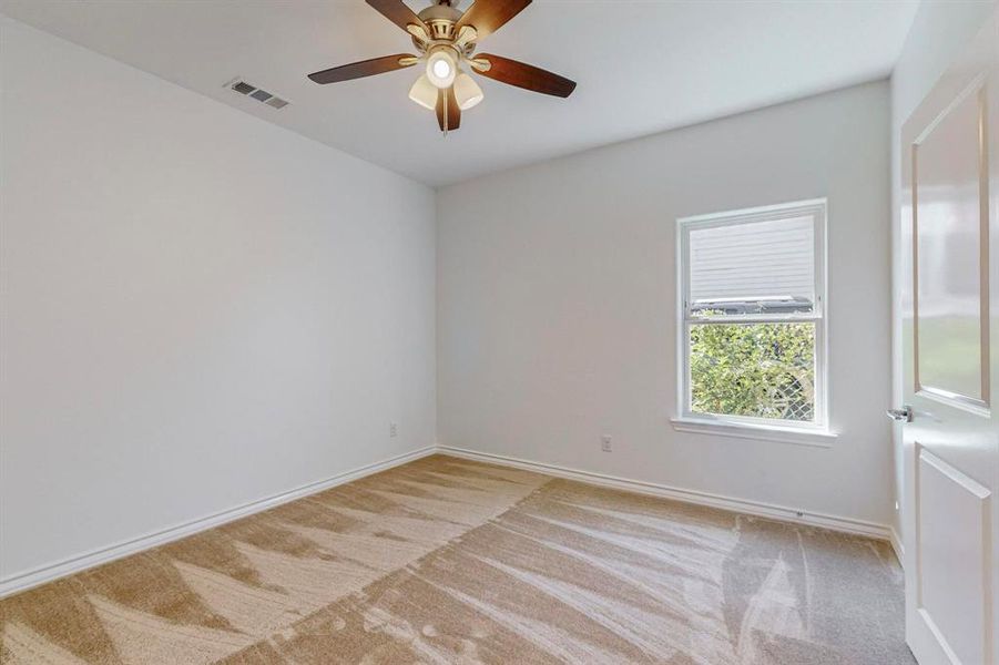 Carpeted bedroom #3 with ceiling fan