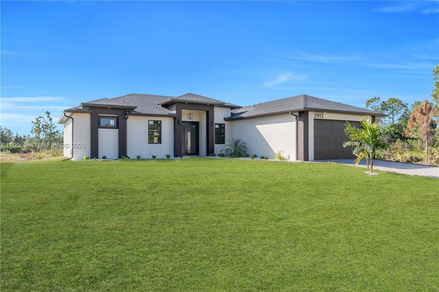 Front exterior of a new home in , Lehigh Acres, FL, highlighting curb appeal (Image 25).