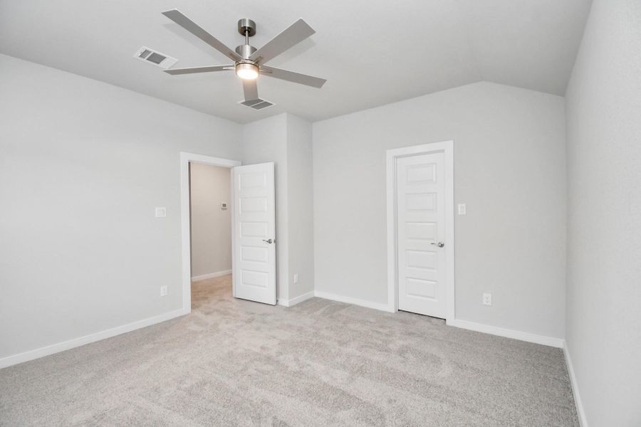 Generously sized secondary bedrooms featuring spacious closets, soft and inviting carpeting underfoot, large windows allowing plenty of natural light, and the added touch of privacy blinds for your personal retreat. Sample photo of completed home with similar floor plan. Actual colors and selections may vary.