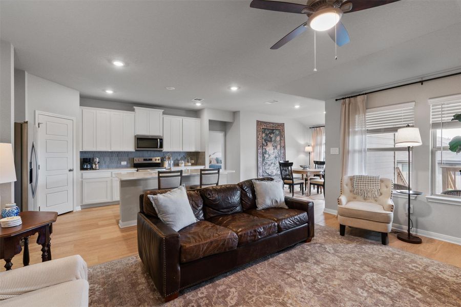 Open-concept living space featuring wood-finish flooring, recessed lighting, and a ceiling fan Open-concept living space featuring wood-finish flooring, recessed lighting, and a ceiling fan