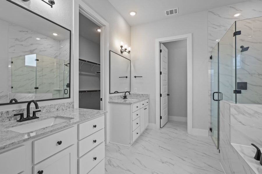 A bathroom with a glass shower. A bathroom with a glass shower.