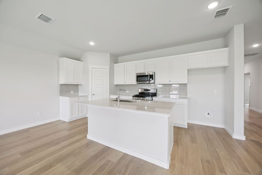 Kitchen in the Hadley home plan by Trophy Signature Homes – REPRESENTATIVE PHOTO Kitchen in the Hadley home plan by Trophy Signature Homes – REPRESENTATIVE PHOTO