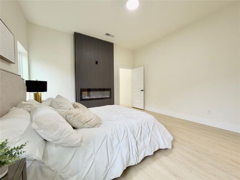 Bedroom with wood finished floors and baseboards