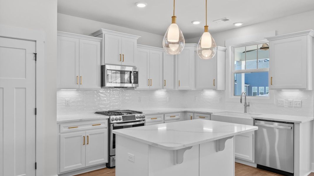 Elegant and compact island anchors this tasteful kitchen with high standards and timeless appeal Elegant and compact island anchors this tasteful kitchen with high standards and timeless appeal