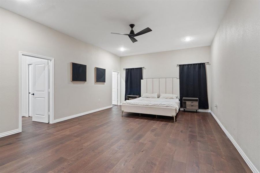 Bedroom with dark wood-style flooring, ceiling fan, and recessed lighting Bedroom with dark wood-style flooring, ceiling fan, and recessed lighting