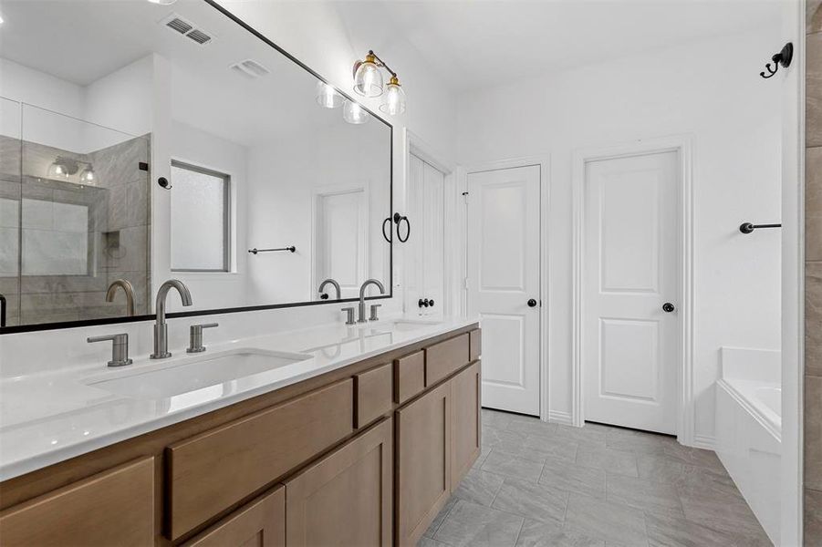 Bathroom featuring independent shower and bath and vanity