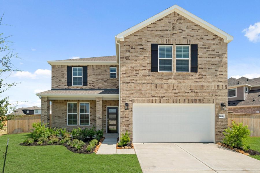 Front exterior of a new home in Sunterra, Katy, TX, highlighting curb appeal (Image 2).