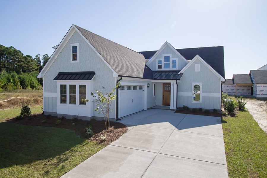 Representative exterior photo of a completed home built from the The Amherst by RobuckHomes in Windwater, Hampstead, NC (Image 23).