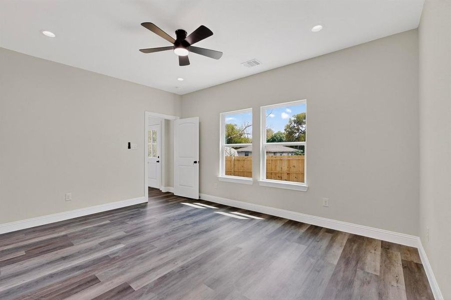 Empty room with light wood finished floors, recessed lighting, and ceiling fan Empty room with light wood finished floors, recessed lighting, and ceiling fan