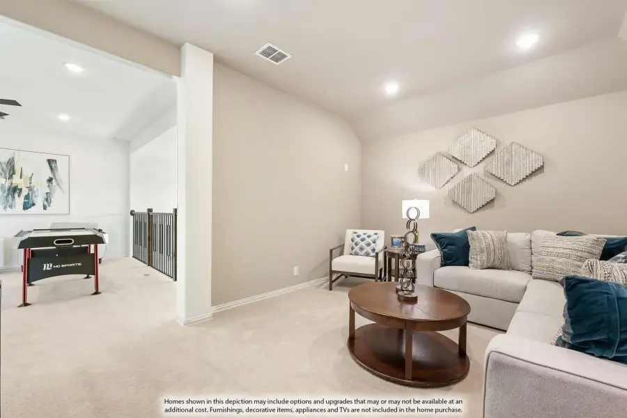 Upstairs loft with sectional sofa, round coffee table, and game table near staircase railing