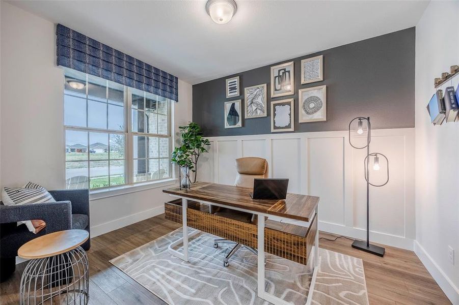 Office area with hardwood / wood-style flooring