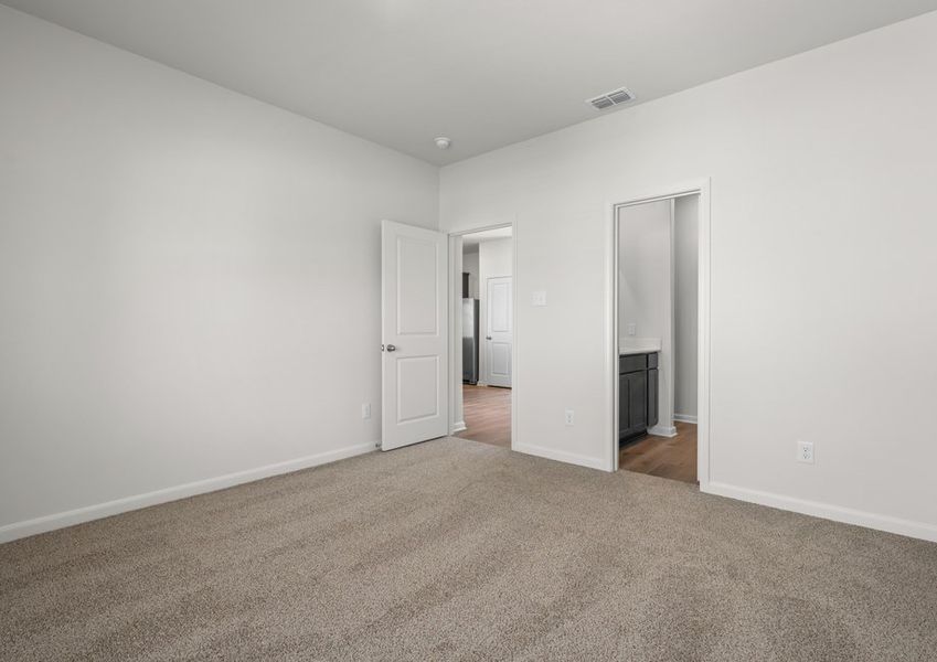 The master suite has a large bedroom, ensuite bathroom and a walk-in closet.