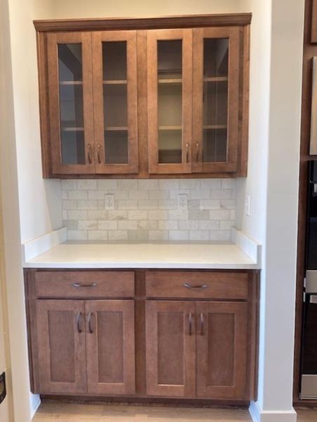 Conveniently located between the Formal Dining Room and Kitchen, across from the Walk-In Kitchen Pantry.  Can serve as a prep area, coffee bar, serving area, or wine bar.  A useful addition to every home!