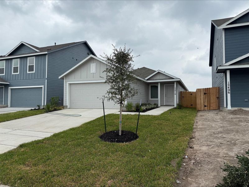Front exterior of a new home in Avalon Ridge: Cottage, Conroe, TX, highlighting curb appeal (Image 23). Front exterior of a new home in Avalon Ridge: Cottage, Conroe, TX, highlighting curb appeal (Image 23).