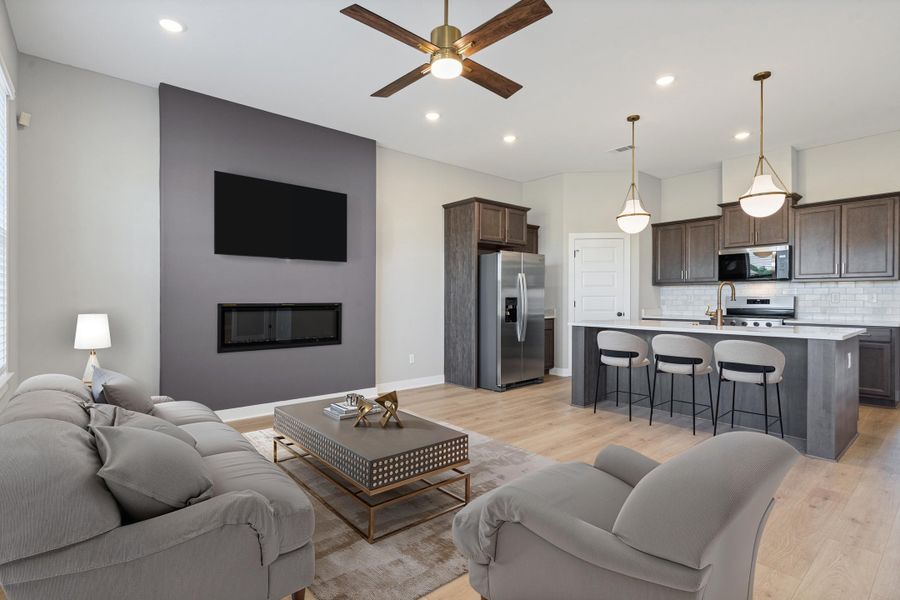 Open-concept living area featuring wood-finish flooring, recessed lighting, and a modern ceiling fan